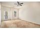 Spacious bedroom with neutral walls, carpet, ceiling fan and door to private balcony at 30 Piedmont Cir, Covington, GA 30016