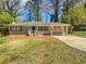 Newly painted one-story house with a landscaped yard and driveway at 2070 Dellwood Pl, Decatur, GA 30032