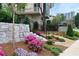 Landscaped area with stone retaining walls, steps and flowering plants at 110 Sheridan Ne Dr, Atlanta, GA 30305