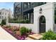 Landscaped entryway featuring blooming flowers and a modern gate at 110 Sheridan Ne Dr, Atlanta, GA 30305
