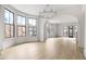 Spacious living room with hardwood floors, bay windows, and chandelier at 110 Sheridan Ne Dr, Atlanta, GA 30305