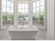 Luxurious bathroom with a freestanding tub and large windows at 110 Sheridan Ne Dr, Atlanta, GA 30305