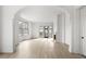 Open living room with hardwood floors, fireplace, and arched doorways at 110 Sheridan Ne Dr, Atlanta, GA 30305