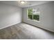 Bright bedroom with grey carpet and large window at 5789 Wellborn Creek Dr, Lithonia, GA 30058