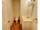 Small bathroom with toilet, sink, and tiled floor at 2921 Lenox Ne Rd # 303, Atlanta, GA 30324