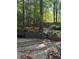 Wooded backyard with steps leading to a private patio area at 1959 Grand Prix Ne Dr, Atlanta, GA 30345