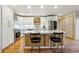 Updated kitchen featuring white cabinets, an island, stainless steel appliances, and wood floors at 1959 Grand Prix Ne Dr, Atlanta, GA 30345