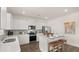 Modern kitchen with white cabinets, stainless steel appliances, and quartz countertops at 664 Edgar St, Hampton, GA 30228