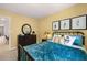 Bedroom with teal bedding and dark dresser at 2711 Honey Locust Ct # 64, Loganville, GA 30052