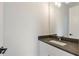 Simple bathroom with dark granite countertop and white vanity at 2174 Avion Way # 11, Chamblee, GA 30341