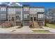 Three-story townhomes with gray and brick exterior, two-car garages, and staircases at 2174 Avion Way # 11, Chamblee, GA 30341