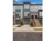 Modern three-story townhome with gray and brick exterior, two-car garage, and a staircase at 2174 Avion Way # 11, Chamblee, GA 30341