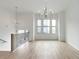 Light and airy living room with hardwood floors, large windows, and modern chandelier at 2174 Avion Way # 11, Chamblee, GA 30341