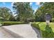 Landscaped front yard with a circular driveway and lush greenery at 2390 Sassafrass Ln, Powder Springs, GA 30127