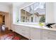 White kitchen with sink, large window, and marble countertops at 3364 Knollwood Nw Dr, Atlanta, GA 30305