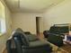 Living room featuring two black leather couches and a patterned rug at 3321 S Norcross Tucker Rd, Tucker, GA 30084
