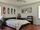 Bedroom with a double bed, wall decor, and bookshelves at 3321 S Norcross Tucker Rd, Tucker, GA 30084