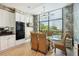 Modern kitchen with white cabinets, granite counters, and breakfast area at 750 Park Ne Ave # 6S, Atlanta, GA 30326
