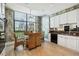 Bright eat-in kitchen with white cabinets, granite counters, and city views at 750 Park Ne Ave # 6S, Atlanta, GA 30326