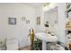 Elegant powder room with pedestal sink, decorative accents, and built-in shelving at 750 Park Ne Ave # 6S, Atlanta, GA 30326