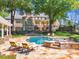 Luxury pool with flagstone patio and lounge chairs at 10955 Stroup Rd, Roswell, GA 30075