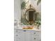 Bathroom with a palm tree mural, marble vanity, and ornate gold mirror at 10955 Stroup Rd, Roswell, GA 30075