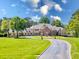 Grand estate with circular driveway and lush landscaping at 10955 Stroup Rd, Roswell, GA 30075
