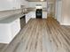 Bright kitchen with white cabinets, granite countertops, and LVP flooring at 3316 Merlot Pass, Lawrenceville, GA 30044