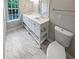 Modern bathroom with double vanity, marble-look flooring, and a large mirror at 3316 Merlot Pass, Lawrenceville, GA 30044