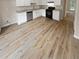 Modern kitchen featuring white cabinets, granite countertops, and LVP flooring at 3316 Merlot Pass, Lawrenceville, GA 30044