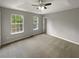 Spacious carpeted bedroom with two windows and ceiling fan at 3316 Merlot Pass, Lawrenceville, GA 30044