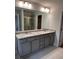 Double vanity bathroom with granite countertop and large mirror at 2270 Highridge Point Dr, Lithia Springs, GA 30122