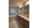 Bathroom boasts double vanity, granite countertop and garden tub at 2270 Highridge Point Dr, Lithia Springs, GA 30122