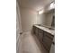 Double vanity bathroom with granite countertop and large mirror at 2270 Highridge Point Dr, Lithia Springs, GA 30122