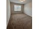 Spacious bedroom with neutral carpeting and large window at 2270 Highridge Point Dr, Lithia Springs, GA 30122
