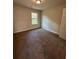Bright bedroom with neutral carpeting and large window at 2270 Highridge Point Dr, Lithia Springs, GA 30122