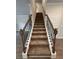 Elegant staircase with dark wood railings and carpeted steps at 2270 Highridge Point Dr, Lithia Springs, GA 30122