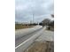 Road intersection with traffic signals and businesses in the distance at 806 Auburn Rd, Auburn, GA 30011