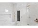 Walk-in shower with marble and pebble tile, built-in seat at 165 Underwood Dr, Atlanta, GA 30328