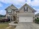 Two story house with neutral siding and a two car garage at 4014 Creekshire Trl, Canton, GA 30115