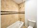 Bathroom with beige tile shower/tub surround and toilet at 8740 Roswell Rd # 9D, Atlanta, GA 30350
