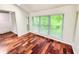 Sunroom with hardwood floors and wall of windows at 8740 Roswell Rd # 9D, Atlanta, GA 30350