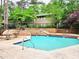 Community pool with brick deck and surrounding landscaping at 8740 Roswell Rd # 9D, Atlanta, GA 30350