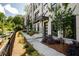 Modern townhome with white brick exterior and a landscaped walkway at 517 Whitlox Nw Rd, Atlanta, GA 30318