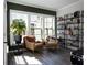 Cozy reading room with two armchairs, built-in shelving, and hardwood floors at 517 Whitlox Nw Rd, Atlanta, GA 30318