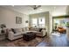 Spacious living room with hardwood floors, sectional sofa, and large windows at 517 Whitlox Nw Rd, Atlanta, GA 30318
