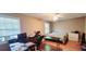 Bright bedroom with hardwood floors, a queen bed, and a workspace at 5970 Wintergreen Rd, Norcross, GA 30093