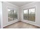 Bedroom with large windows offering abundant natural light and hardwood floors at 2431 Siskin Square Rd, Duluth, GA 30096