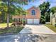 Brick two-story house with a two car garage and landscaped yard at 3909 Micah Ln, Ellenwood, GA 30294