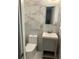 Updated bathroom with gray vanity, marble tile, and modern fixtures at 1433 Woodland Sw Ter, Atlanta, GA 30311